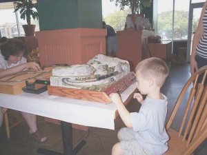 dcp04002 boy operating zscale, mom learning to rerail. zscale.jpg